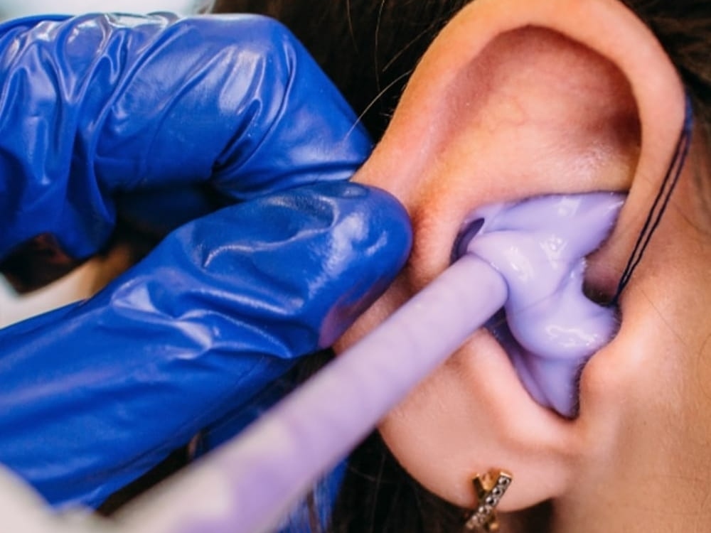Doctor of Audiology taking a custom ear impression for hearing protection at Hear Today Hearing Aids in Corpus Christi, TX