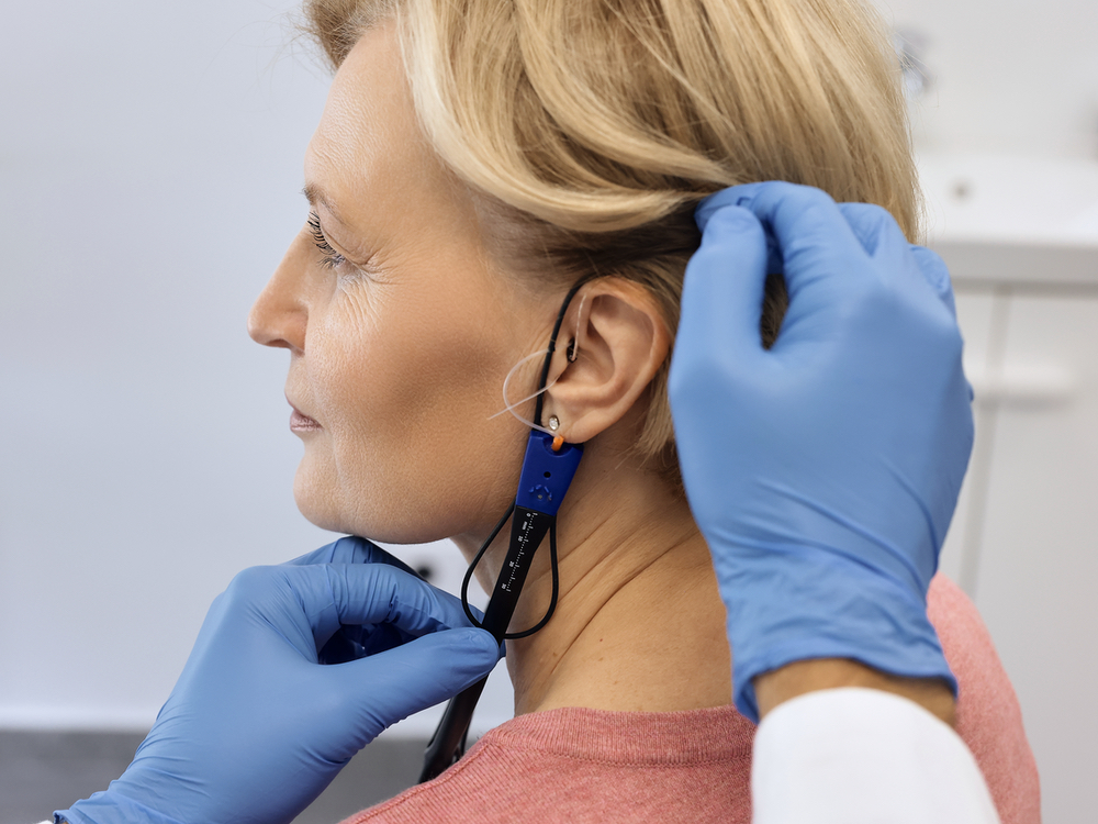 Doctor of Audiology performing real ear measurement on a hearing aid patient at Hear Today Hearing Aids in Corpus Christi, TX